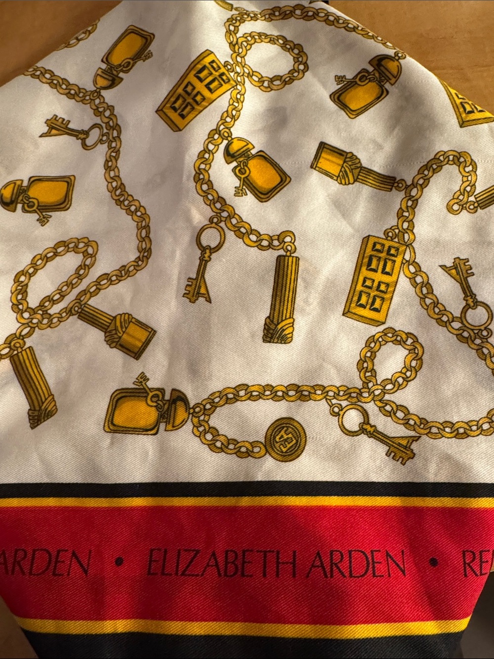 Elizabeth Arden White Scarf with Gold Chain Motif and Red Border